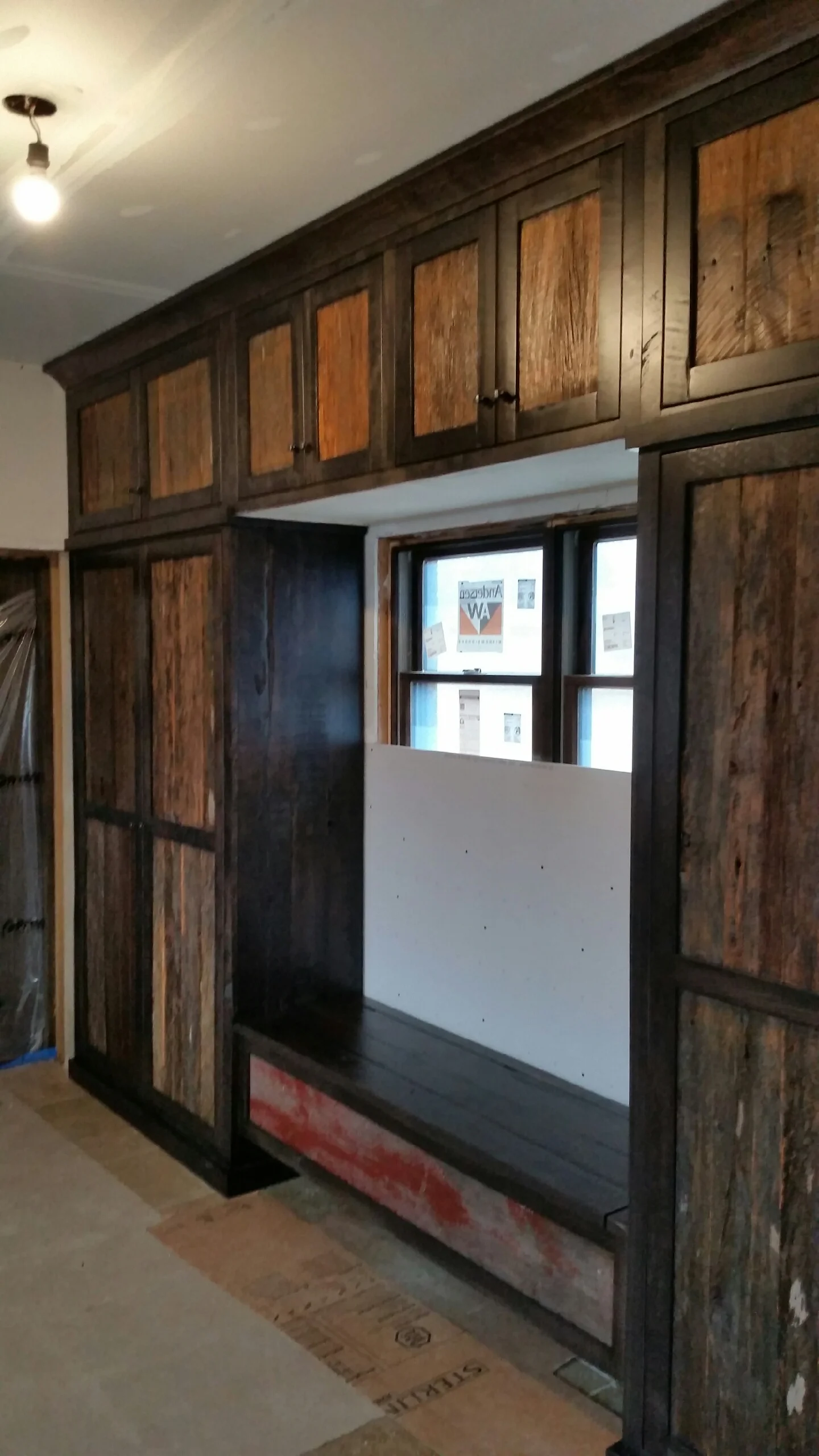 Dark wood cabinetry with recessed panels and integrated storefront window display