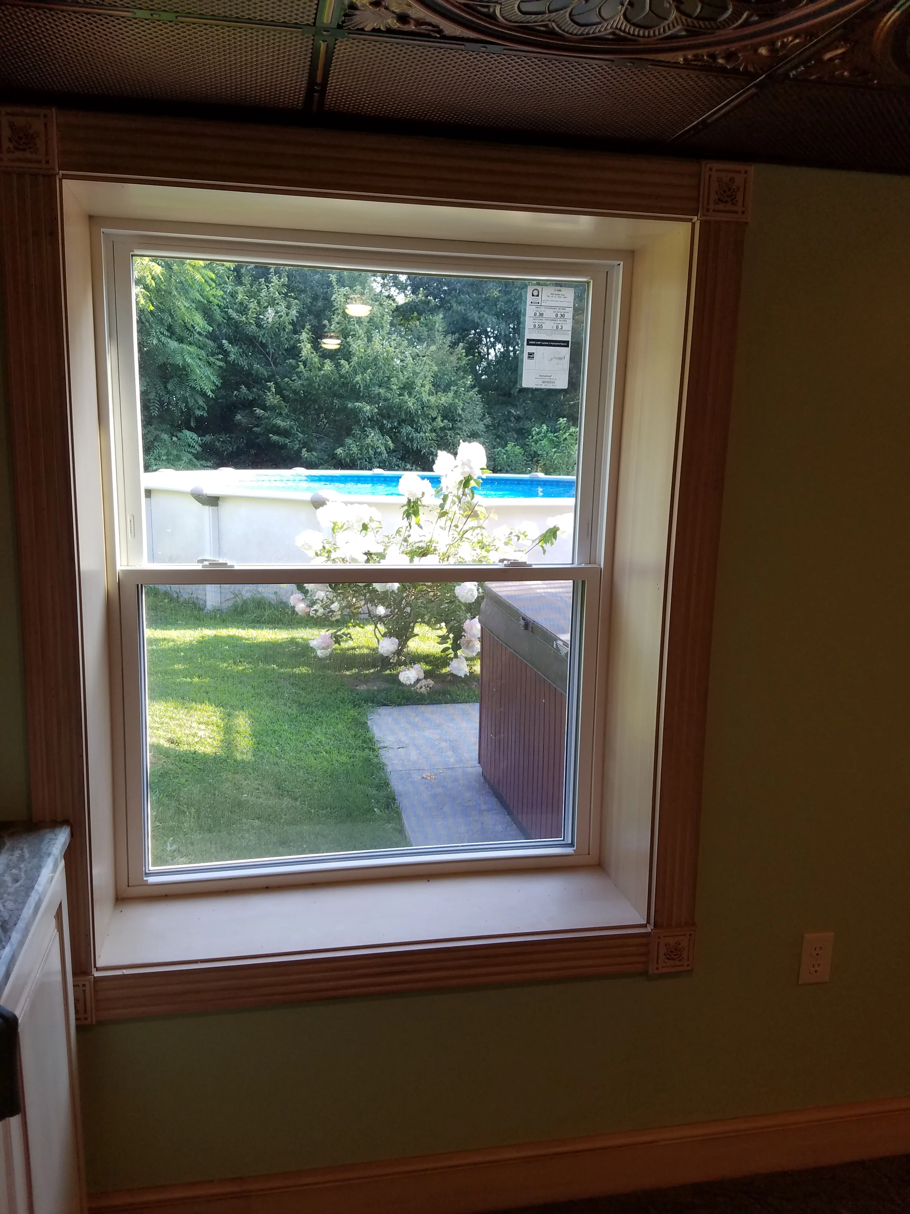Double-hung window with aluminum-clad frame and wood interior trim in residential setting