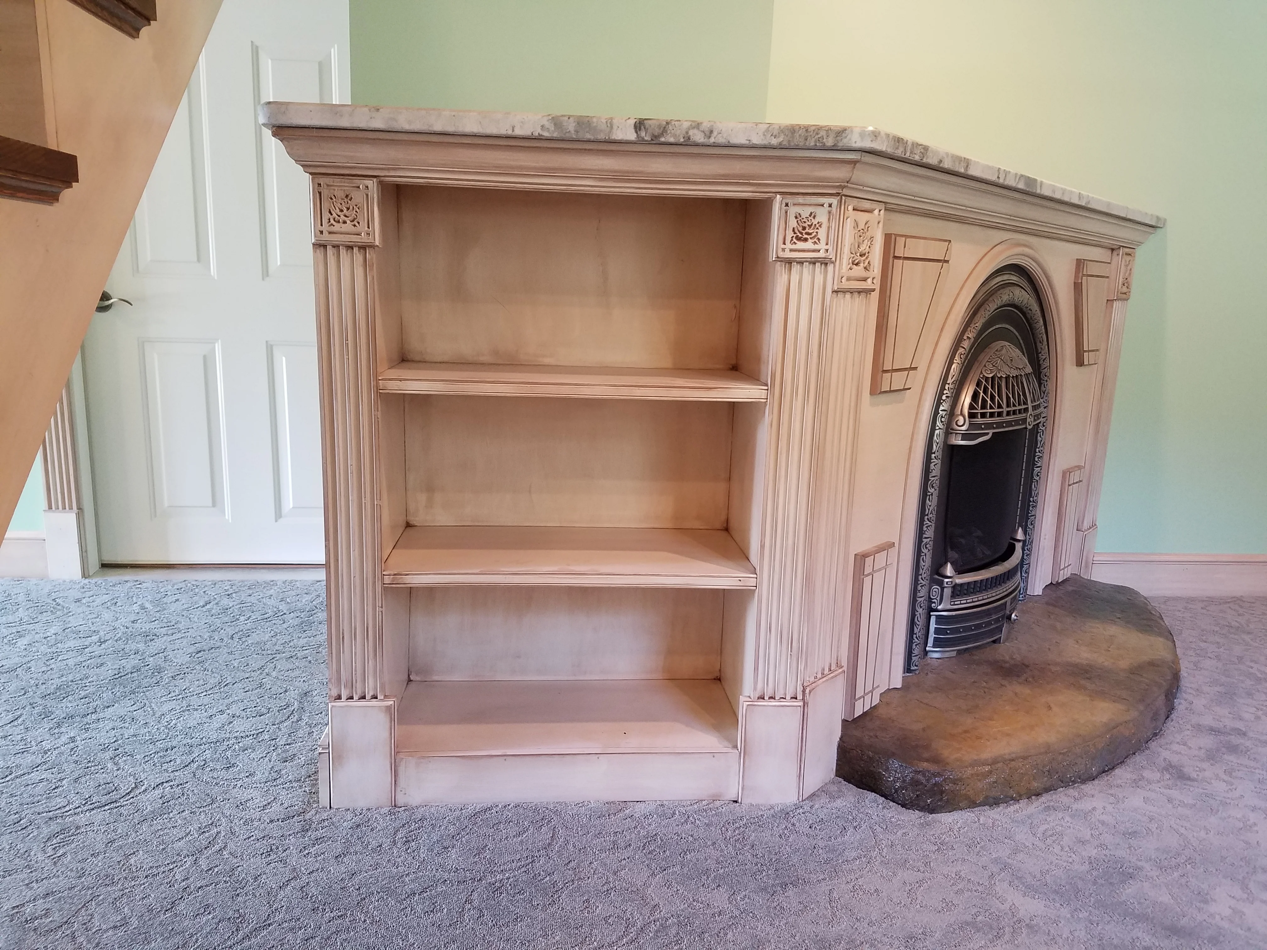 Custom wood fireplace mantel with shelving, fluted columns, and decorative corbels